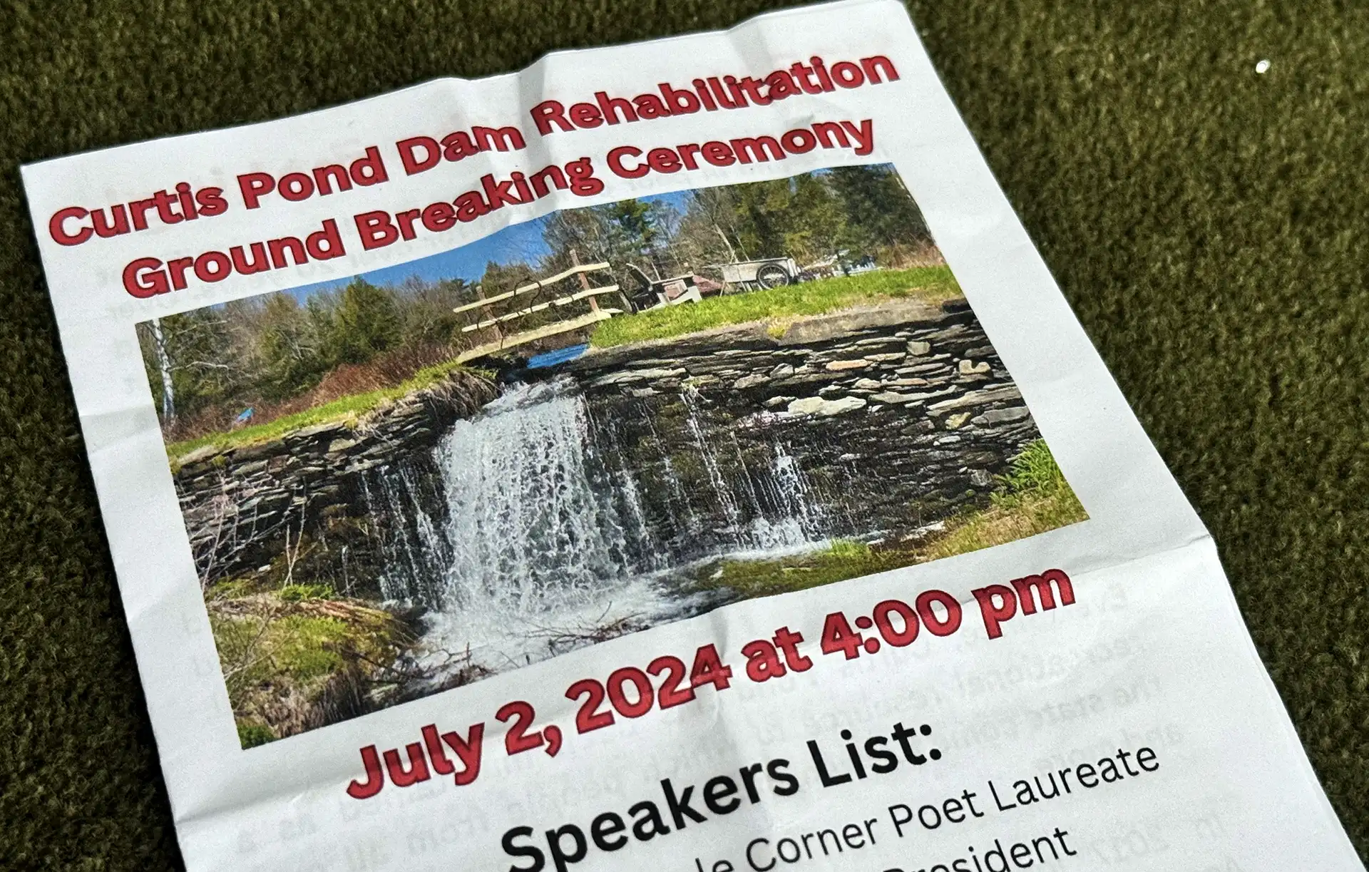 photo of a flyer for the curtis pond dam rehabilitation ground breaking ceremony in july 2024