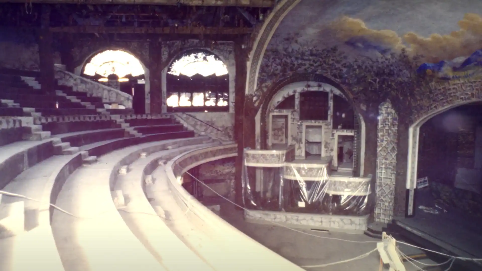 photo inside the elgin theater with seats removed and balcony seating draped in plastic.
